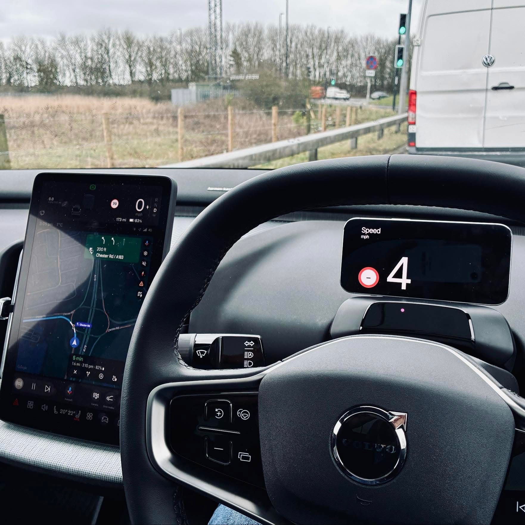 Volvo EX30 dashboard showing NordHUD app on phone mount as driver display